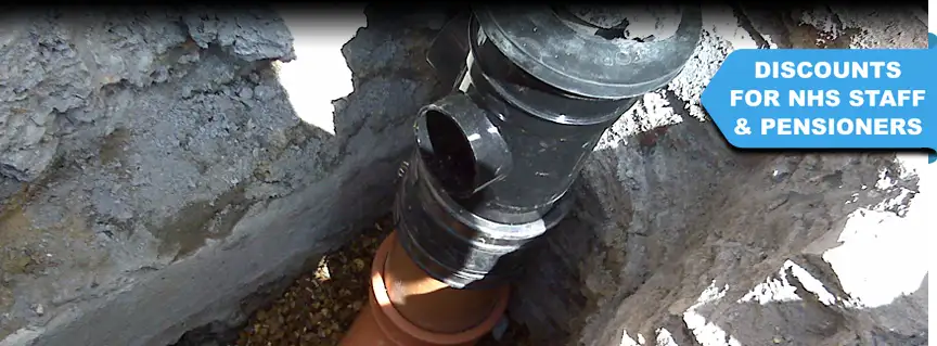 Excavation for drainage installation to set up a new drainage system outside a house in Worthing, West Sussex