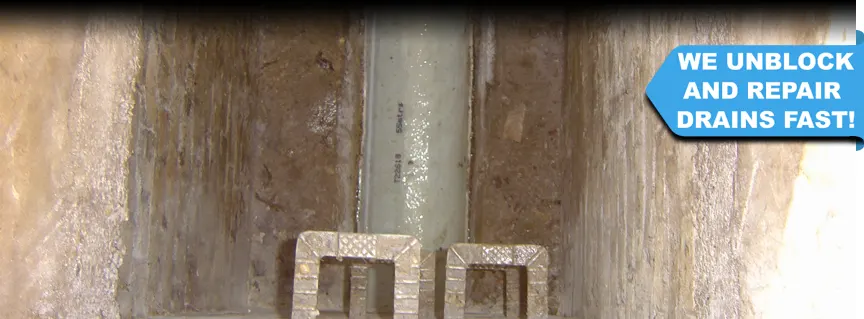 Inspecting the newly installed lining through the opened manhole cover, looking down into the drainage in Midhurst, West Sussex