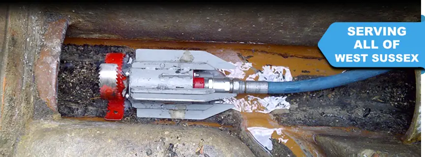 A high-power root cutter is set in the drain, ready to cut through the roots in Chichester West Sussex