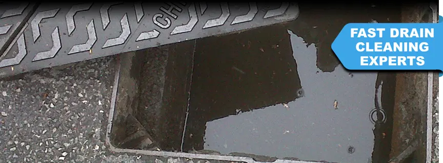 An open manhole cover showing a fully blocked drain in Midhurst West Sussex – requiring urgent unblocking services